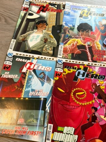Four comic books from DC Comics' Wonder Comics series laid out on a wooden surface. The covers feature colorful superhero artwork, including characters resembling Flash and The Flash, with titles such as 'The Phantom' and 'Mr.