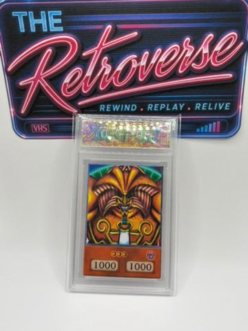 A Yu-Gi-Oh! holographic card in a clear plastic protective case, displayed in front of a blue and pink 'The Retroverse' VHS box cover.