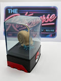 A Pokémon Omanyte figurine inside a clear dome display case with a black and red base, set against a white background with a neon sign behind it.