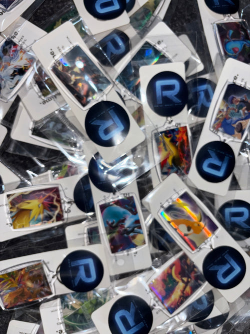 Collection of trading cards with 'R' logo on a reflective surface