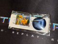 Pokémon trading card with a blue circular item on a black background