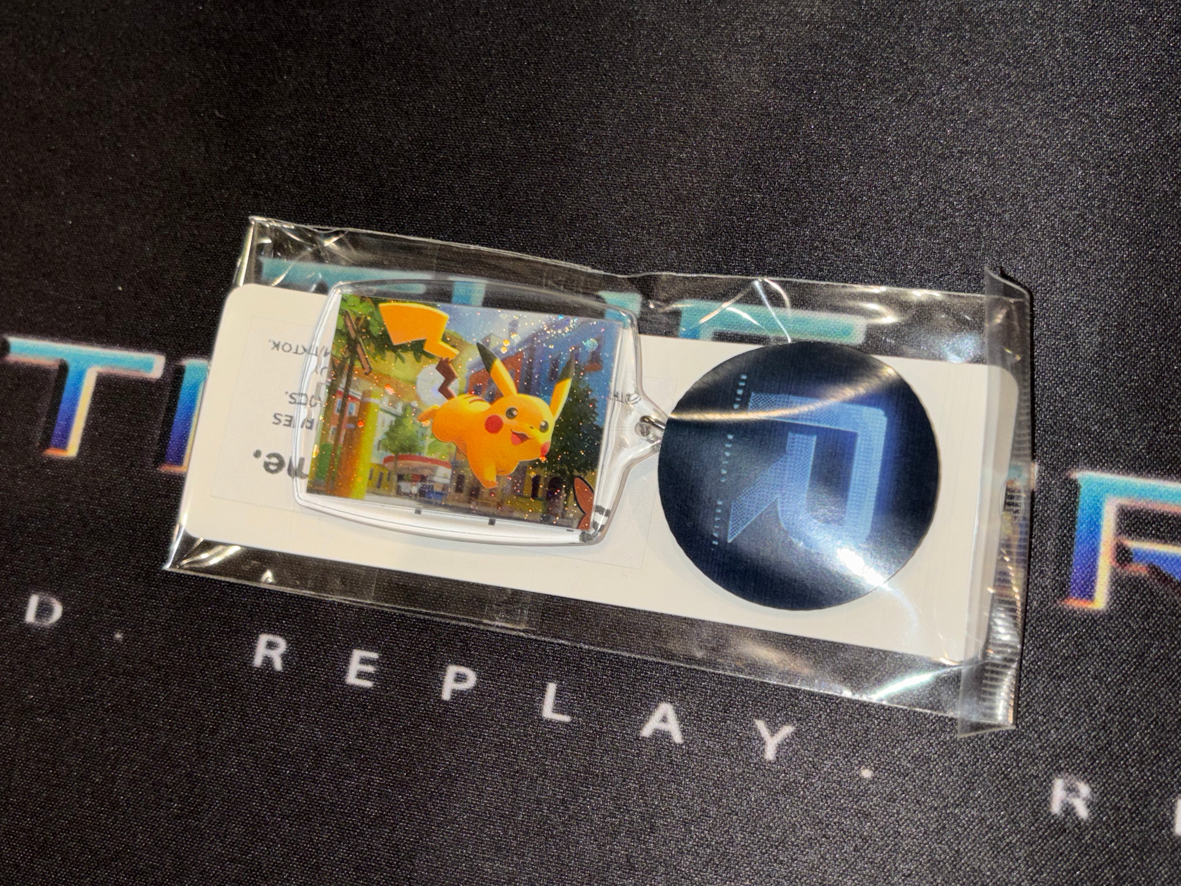 Pokémon trading card with a blue circular item on a black background