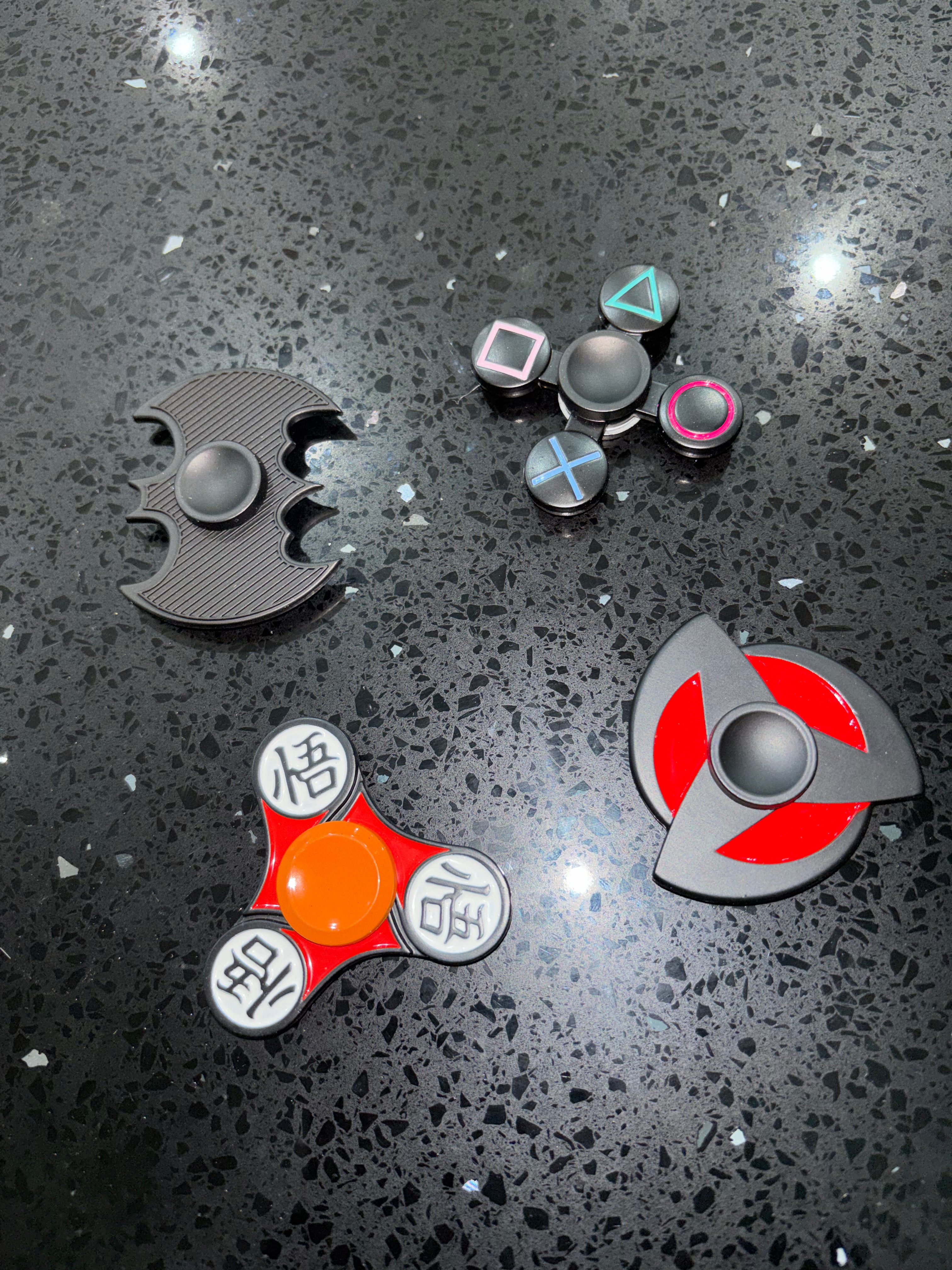 Collection of fidget spinners and related items on a reflective surface