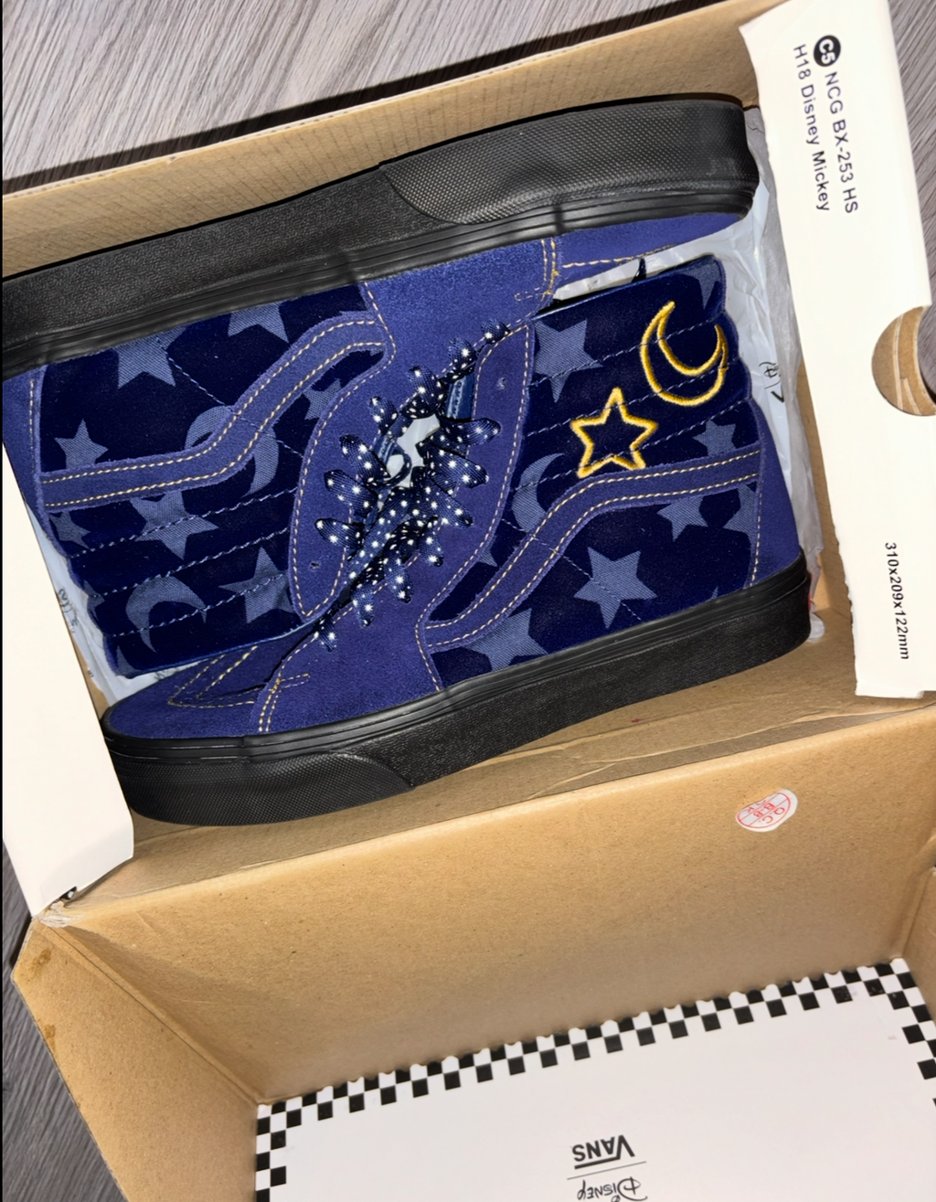 Blue sneaker with star and moon design in a box