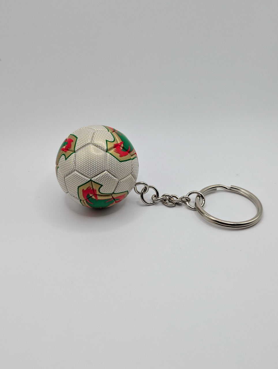 Keychain shaped like a soccer ball with floral patterns on a white background