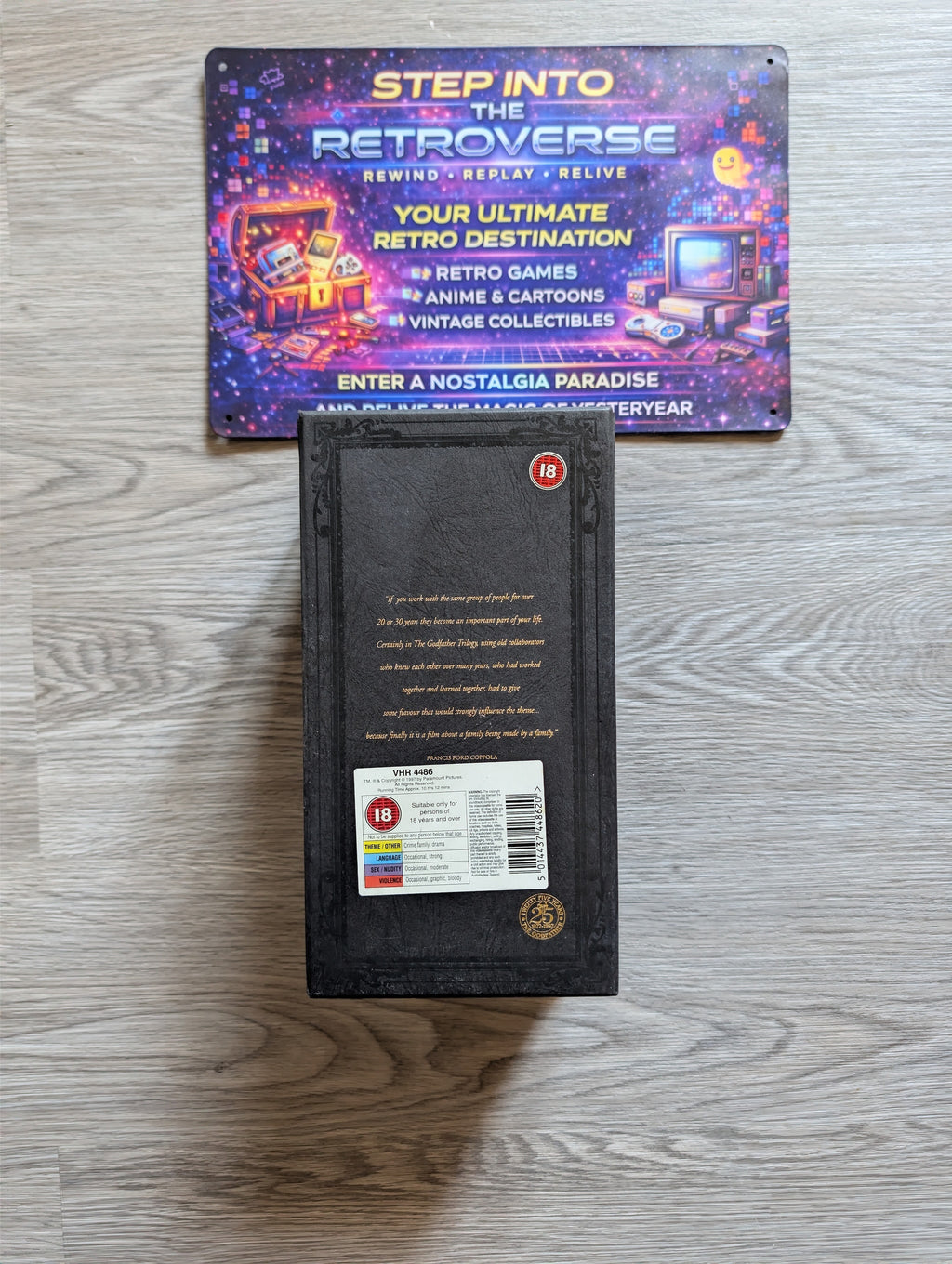 Godfather trilogy VHS set, featuring a promotional sign for 'Step into the Retroverse' above it.