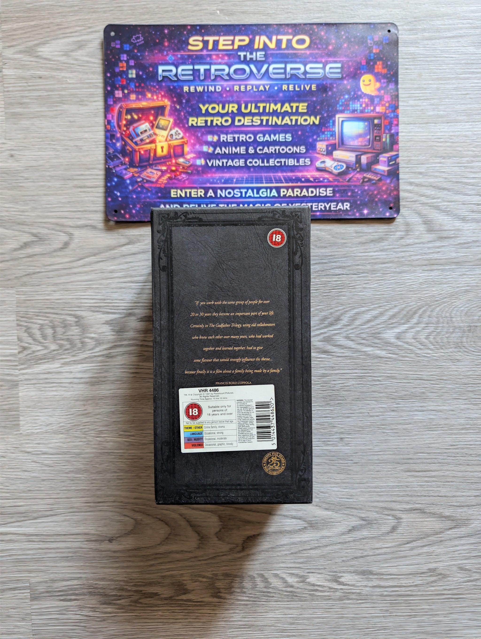 Godfather trilogy VHS set, featuring a promotional sign for 'Step into the Retroverse' above it.