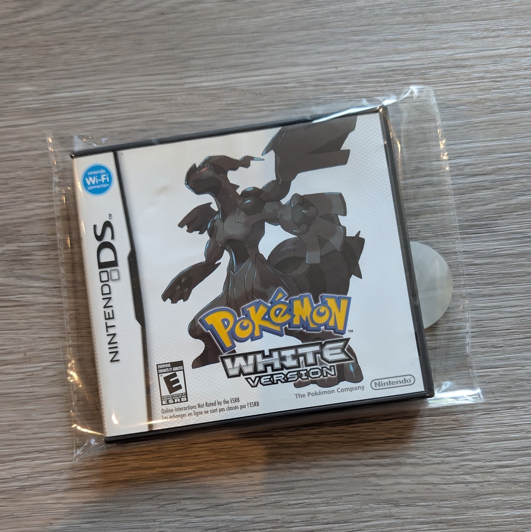 Pokémon White Version game case for Nintendo DS on a wooden surface